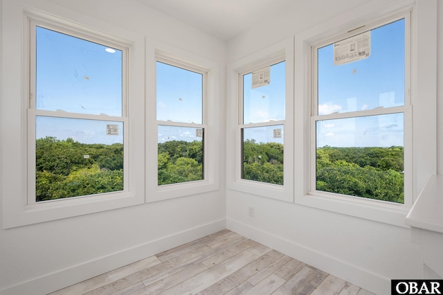 2002 Sandpiper Rd Lot 12, Corolla, NC 27927 - unfurnished sunroom featuring healthy amount of natural light and wood finished floors