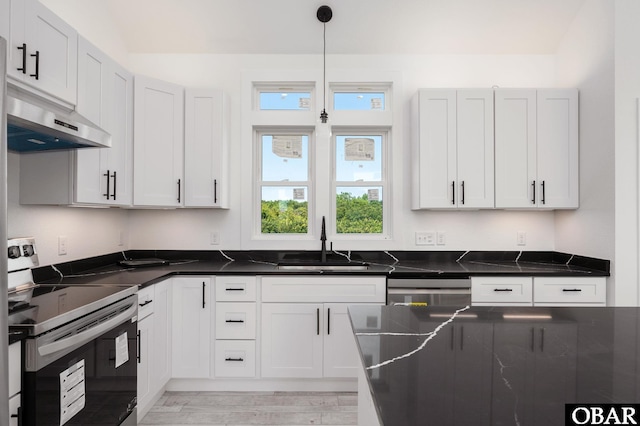 2002 Sandpiper Rd Lot 12, Corolla, NC 27927 - kitchen with stainless steel electric stove, under cabinet range hood, dark countertops, and light wood-style flooring