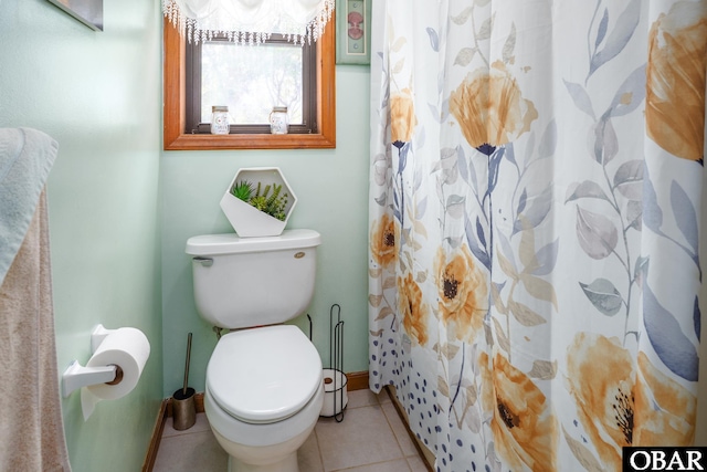 full bathroom featuring toilet, baseboards, and tile patterned floors