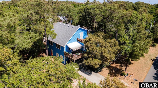 drone / aerial view featuring a wooded view