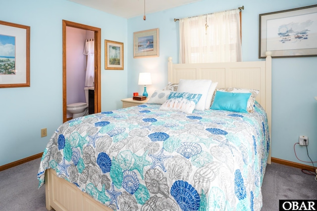 carpeted bedroom with baseboards and ensuite bath