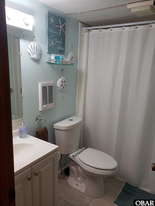 full bathroom featuring vanity, heating unit, tile patterned floors, and toilet