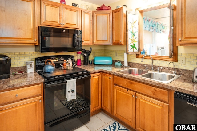 kitchen featuring light tile patterned flooring, a sink, light countertops, tasteful backsplash, and black appliances