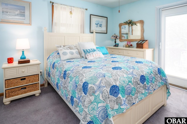 carpeted bedroom with baseboards and multiple windows