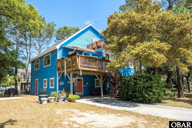 view of front of house featuring stairway, cooling unit, and a wooden deck