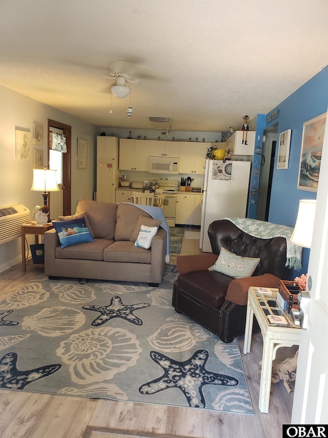 living room featuring a ceiling fan and light wood-type flooring