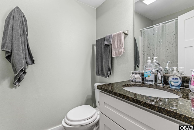 full bath featuring toilet and vanity