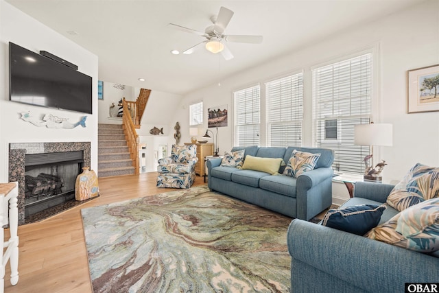 403 Sailfish Dr Unit 403, Manteo, NC 27954 - living room with stairway, a ceiling fan, wood finished floors, and a fireplace with flush hearth