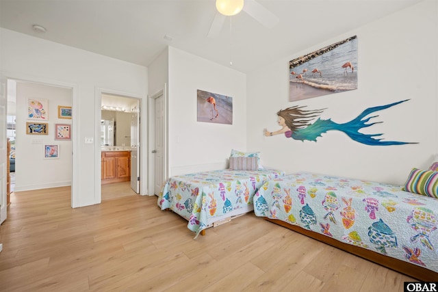 403 Sailfish Dr Unit 403, Manteo, NC 27954 - bedroom with light wood finished floors, ensuite bath, a ceiling fan, and baseboards