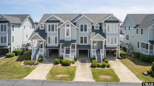 403 Sailfish Dr Unit 403, Manteo, NC 27954 - view of property with a carport, driveway, an attached garage, and board and batten siding