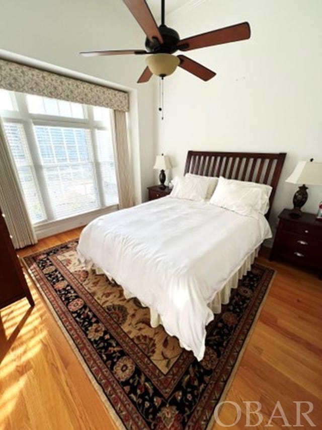 bedroom with ceiling fan and wood finished floors