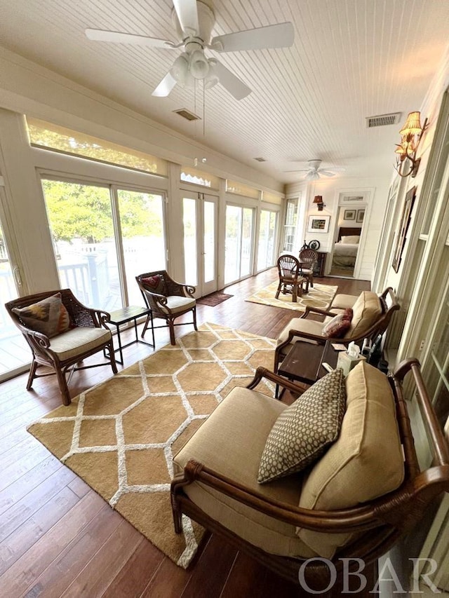 sunroom with french doors, plenty of natural light, and visible vents