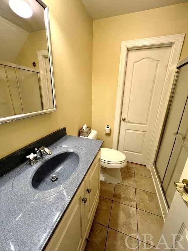 bathroom featuring a stall shower, vanity, toilet, and tile patterned floors