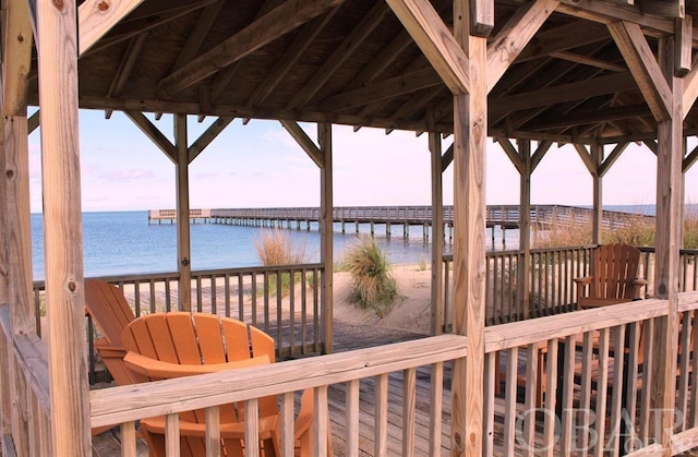 deck with a water view and a beach view