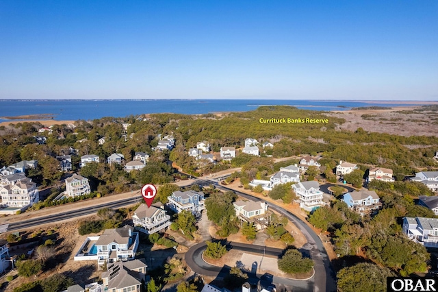 drone / aerial view with a residential view and a water view