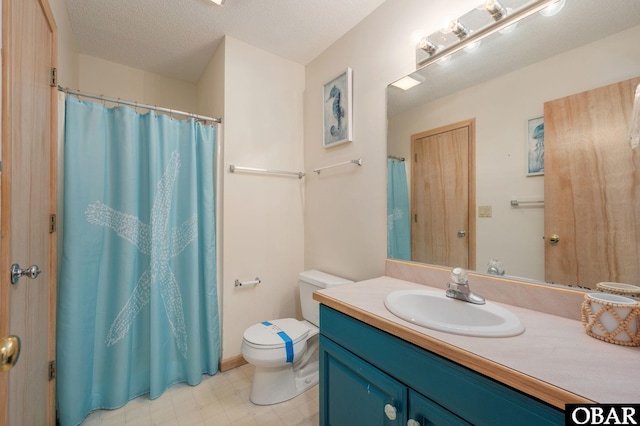 bathroom featuring toilet, a textured ceiling, vanity, and tile patterned floors