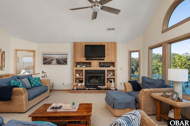 living area featuring carpet floors, a fireplace, visible vents, a ceiling fan, and high vaulted ceiling