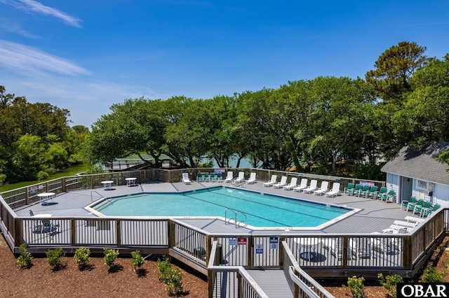 community pool featuring a patio and fence