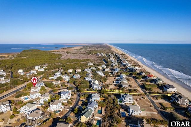 bird's eye view with a water view, a residential view, and a view of the beach