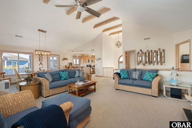 living room featuring ceiling fan with notable chandelier, high vaulted ceiling, carpet flooring, and visible vents