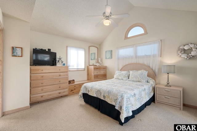 bedroom with lofted ceiling, a textured ceiling, light carpet, a ceiling fan, and baseboards