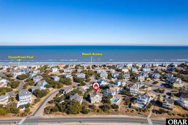 drone / aerial view with a water view and a residential view