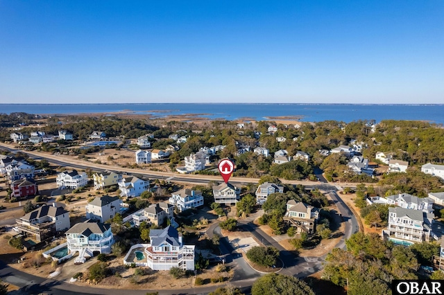 birds eye view of property with a water view and a residential view