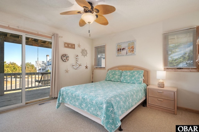 bedroom featuring access to exterior, visible vents, light carpet, ceiling fan, and baseboards