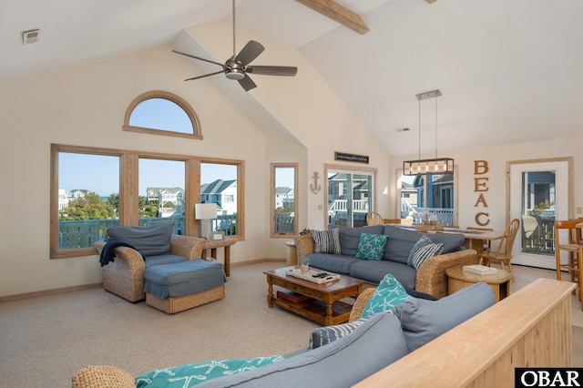 carpeted living room with high vaulted ceiling, visible vents, baseboards, and a ceiling fan