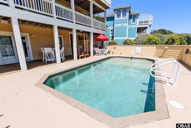 view of swimming pool with a patio area and a fenced in pool