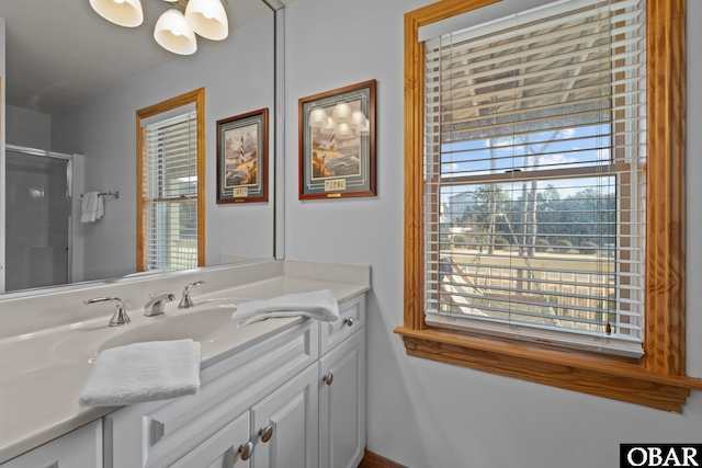 bathroom with a shower with door and vanity