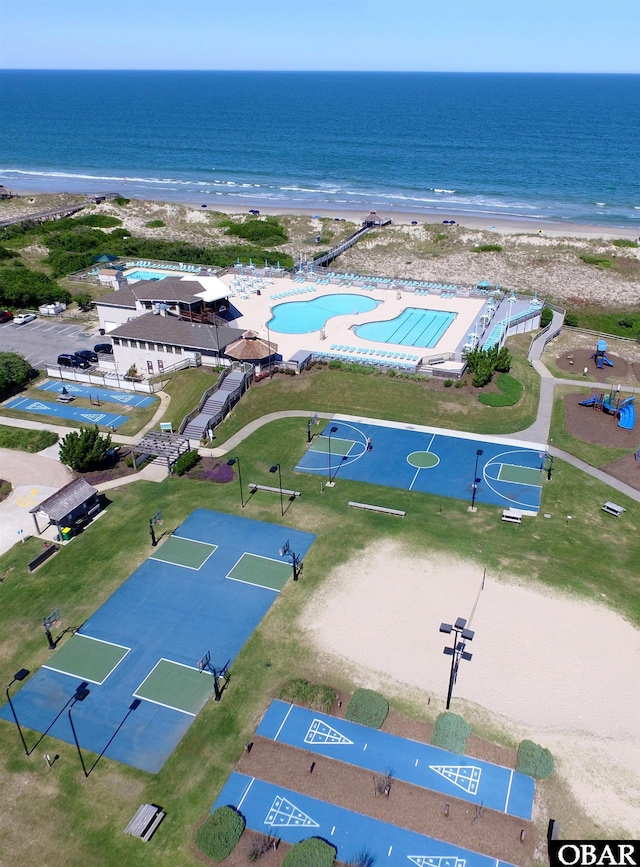 drone / aerial view featuring a water view and a beach view