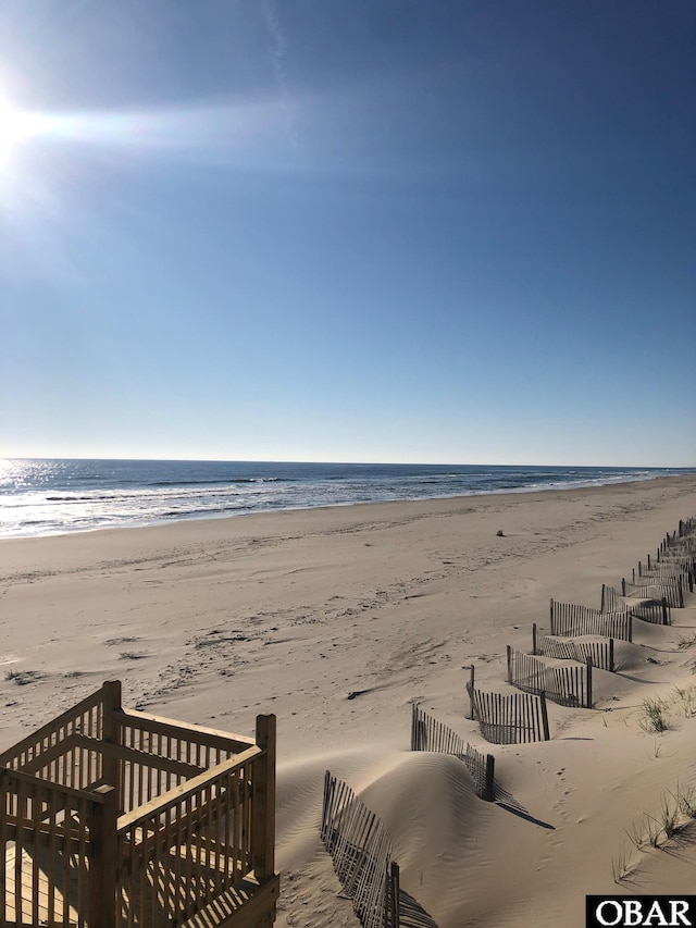 property view of water featuring a beach view