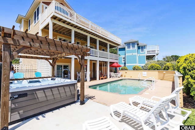 view of swimming pool with a hot tub, a pergola, and a patio