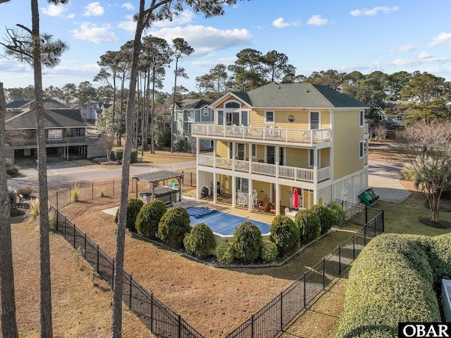 back of property with a patio area, a fenced backyard, and a balcony