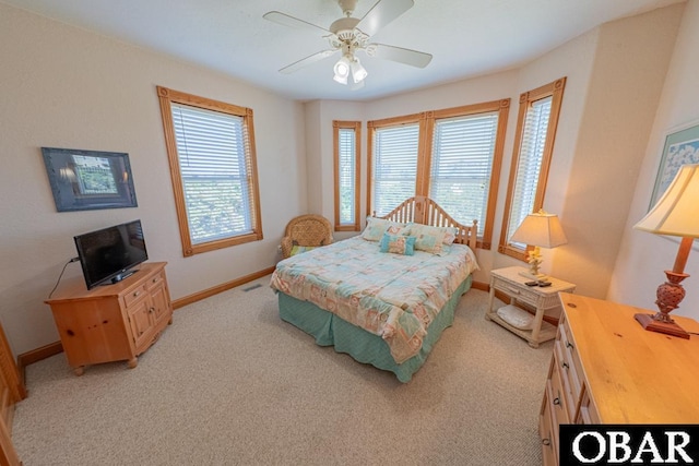 57390 Lighthouse Rd Lot 30, Hatteras, NC 27943 - bedroom with multiple windows, light carpet, and a ceiling fan