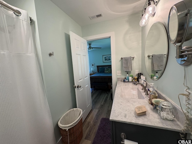 51 Fish Camp Rd, Ocracoke, NC 27960 - ensuite bathroom with a ceiling fan, ensuite bath, visible vents, vanity, and wood finished floors