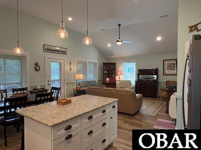 51 Fish Camp Rd, Ocracoke, NC 27960 - kitchen with decorative light fixtures, white cabinets, ceiling fan, and wood finished floors