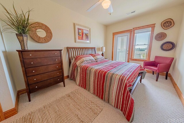 bedroom featuring ceiling fan, light carpet, visible vents, and baseboards