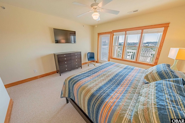 carpeted bedroom with baseboards, visible vents, and a ceiling fan