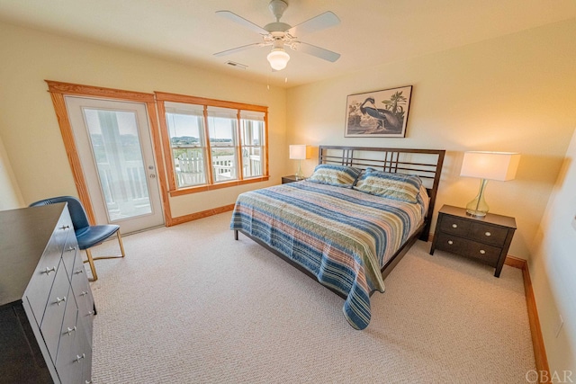 bedroom with access to outside, light colored carpet, visible vents, and baseboards