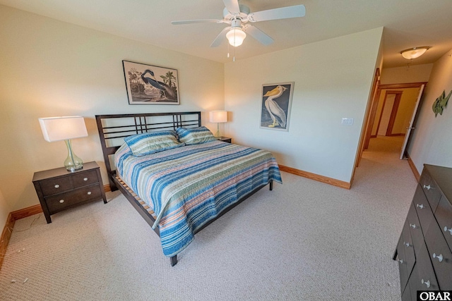 bedroom with ceiling fan, baseboards, and light colored carpet