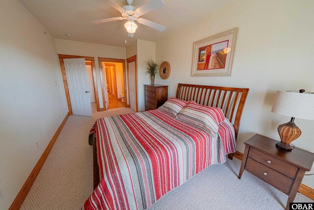 bedroom with light colored carpet, ceiling fan, and baseboards