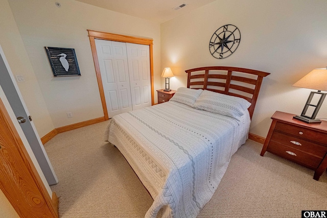 bedroom featuring light carpet, a closet, visible vents, and baseboards