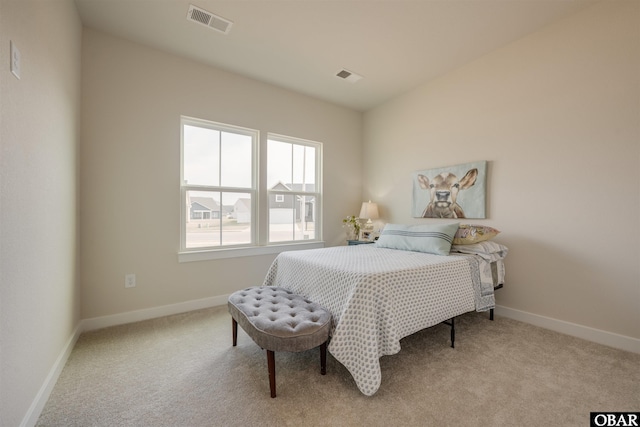 carpeted bedroom with baseboards and visible vents