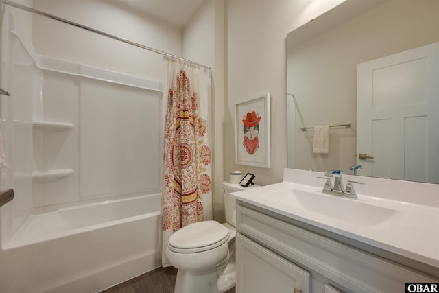 bathroom featuring toilet, wood finished floors, shower / bath combination with curtain, and vanity