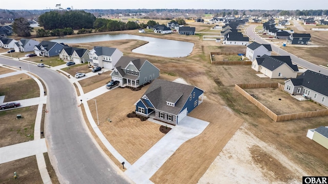 birds eye view of property featuring a water view and a residential view