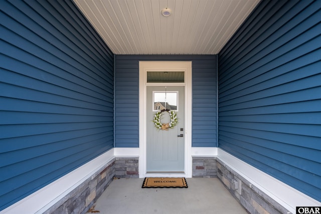 doorway to property with stone siding