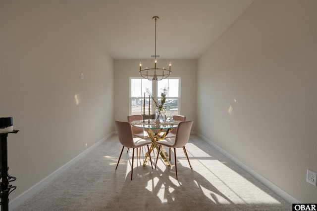 dining space with baseboards, a chandelier, and light colored carpet