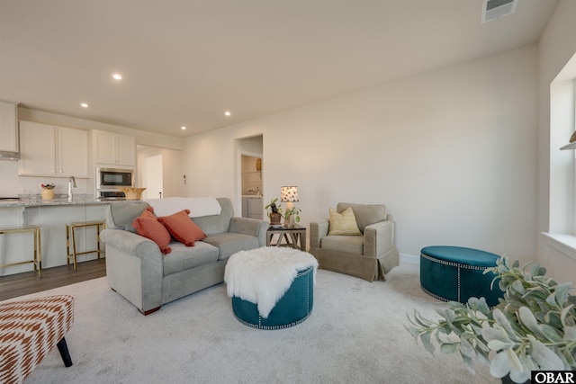 living room with visible vents and recessed lighting